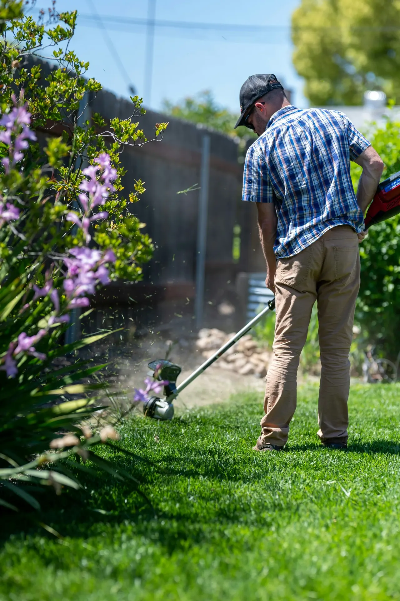 Landscaper trimming grass